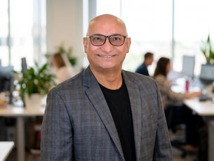 Hitesh Patel, owner of Transworld Business Advisors Capitol Region and Pittsburgh North, standing in a client's office in Harrisburg, PA