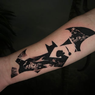 Black and grey Batman tattoo by Nashville tattoo artist Misha Gunderson at Outlier Tattoo. Realistic superhero design with dramatic shading and detailed linework.