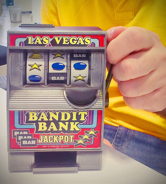 Toy slot machine being held by man
