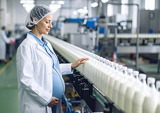 Firefly_create a photorealistic image of a pregnant woman working on a factory line 923050