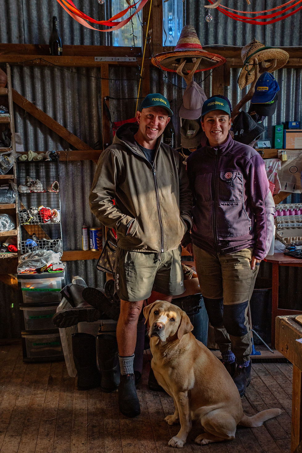 Matt and Helen Barbour with their Labrador, Ali, inside the historic wool shed at Fernbank Wines in North Canterbury.