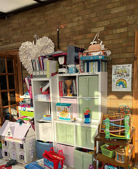 A disorganised playroom with IKEA Kallaz storage.