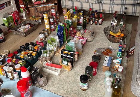 Kitchen items laid out neatly on the floor.
