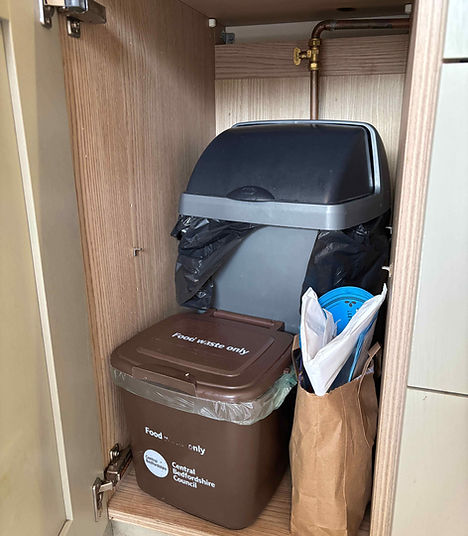 Kitchen bins inside a cupboard.