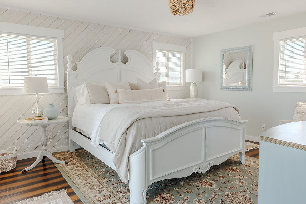 Cozy master bedroom with light textiles in a beach front home in outer banks