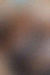 Vauva hymyilee kameralle ristiäisissä