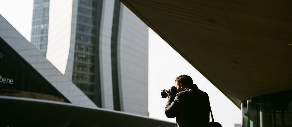 Fotografía de arquitectura contemporánea donde un fotógrafo observa un edificio desde un punto de vista estratégico, destacando la relación entre posición, composición y lenguaje visual en la fotografía arquitectónica.