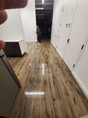 Person mopping shiny hardwood floor