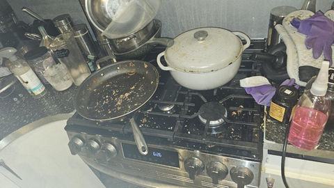 Dirty stovetop with pans and dishes