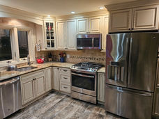Updated kitchen with stainless steel appliances and cream cabinets