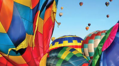 Colorful hot air balloons filling the sky during the Albuquerque Balloon Fiesta event.