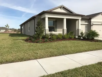 Modern single-story house with lawn and sidewalk