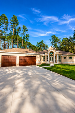 Modern home with double wooden garage doors and design.