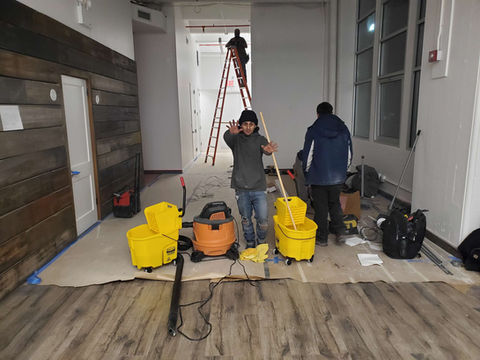 Cleaning crew with equipment in a building