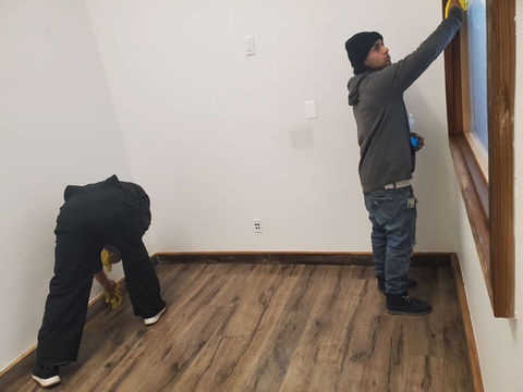 Two cleaners cleaning room