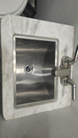 Stainless steel sink in marble countertop