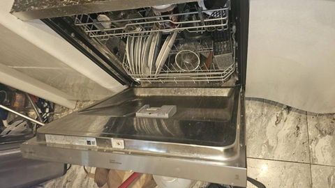 Dirty dishes in stainless steel dishwasher