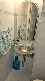 Small bathroom sink with glass vanity