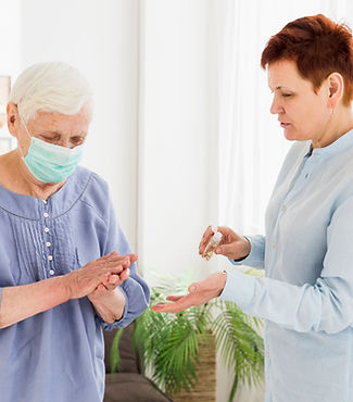 elder-women-sanitizing-hands-while-home.jpg
