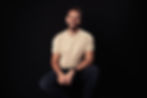 Oliver Kobak smiling against a dark background