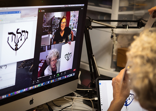 Bobbie at the computer discussing handcrafted custom jewelry with customer