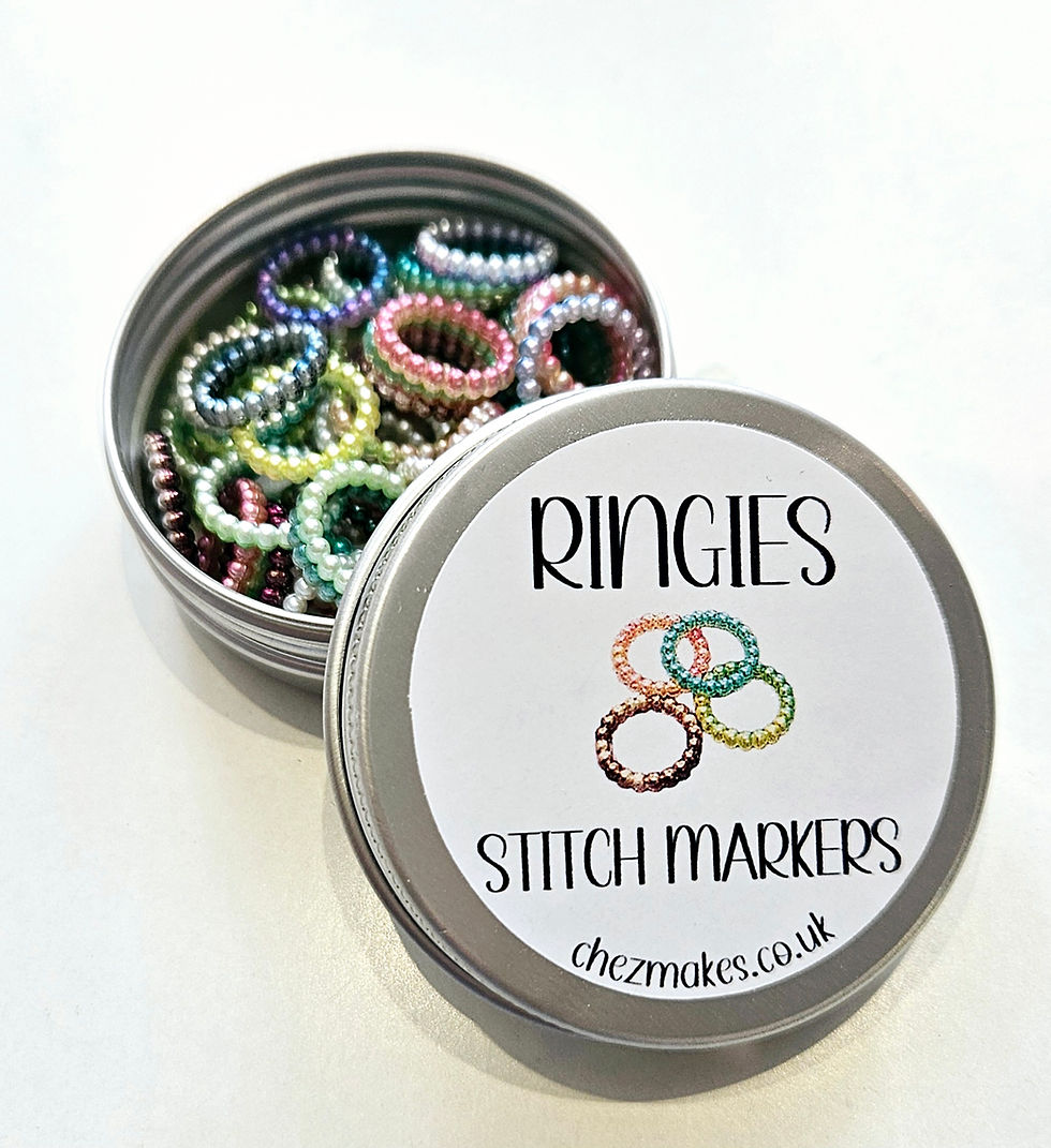 Thumbnail: ringies stitch markers tin with multi coloured plastic rings inside. Each ring is textured with little bobbles