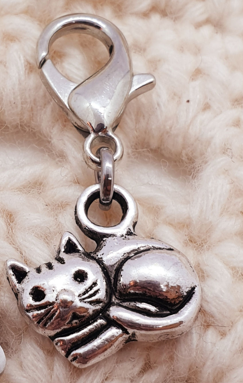 Thumbnail: kitten silver coloured metal charm with lobster clasp on crochet background