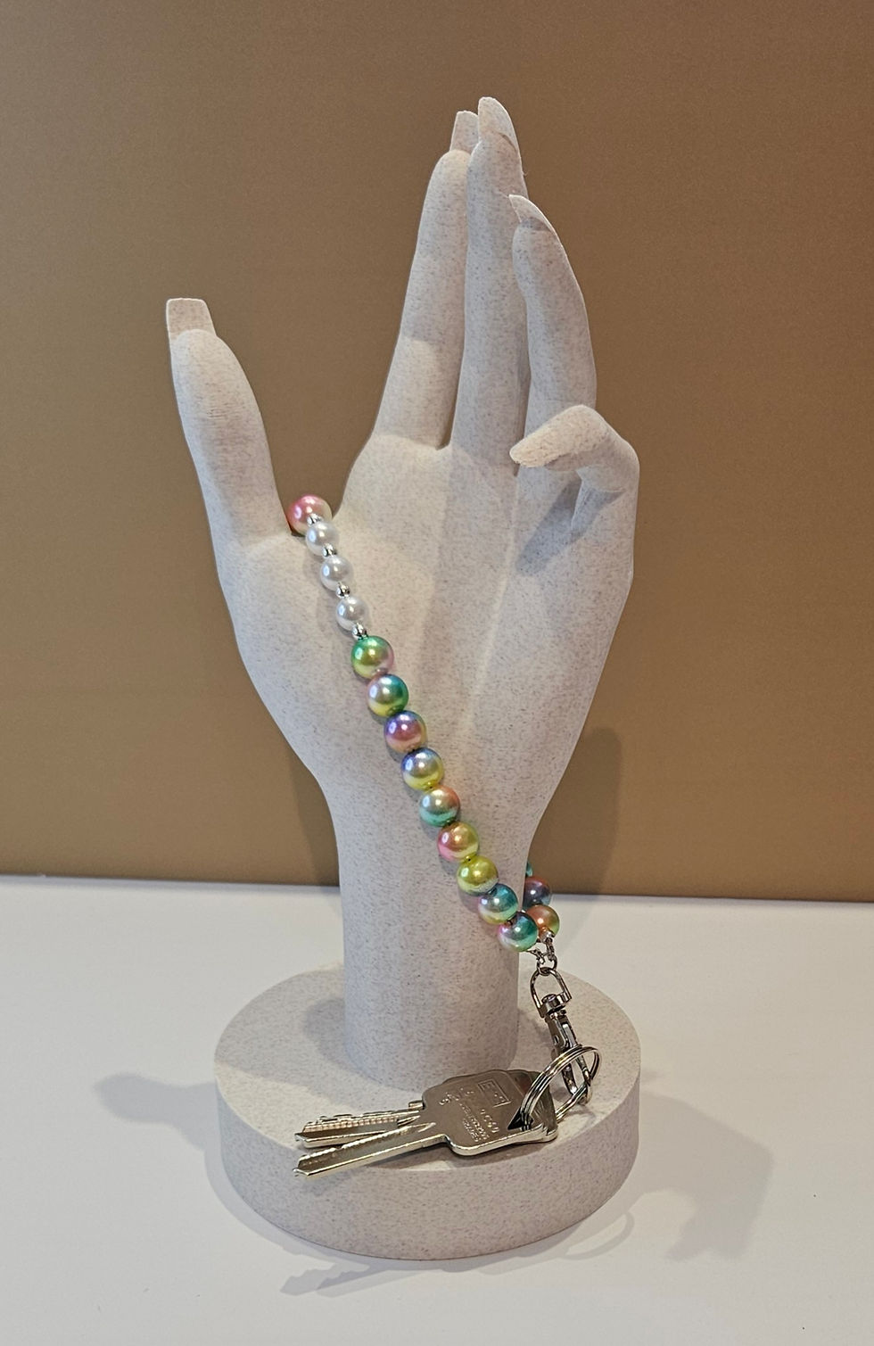 Thumbnail: rainbow bead wrist strap keychain displayed on a hand
