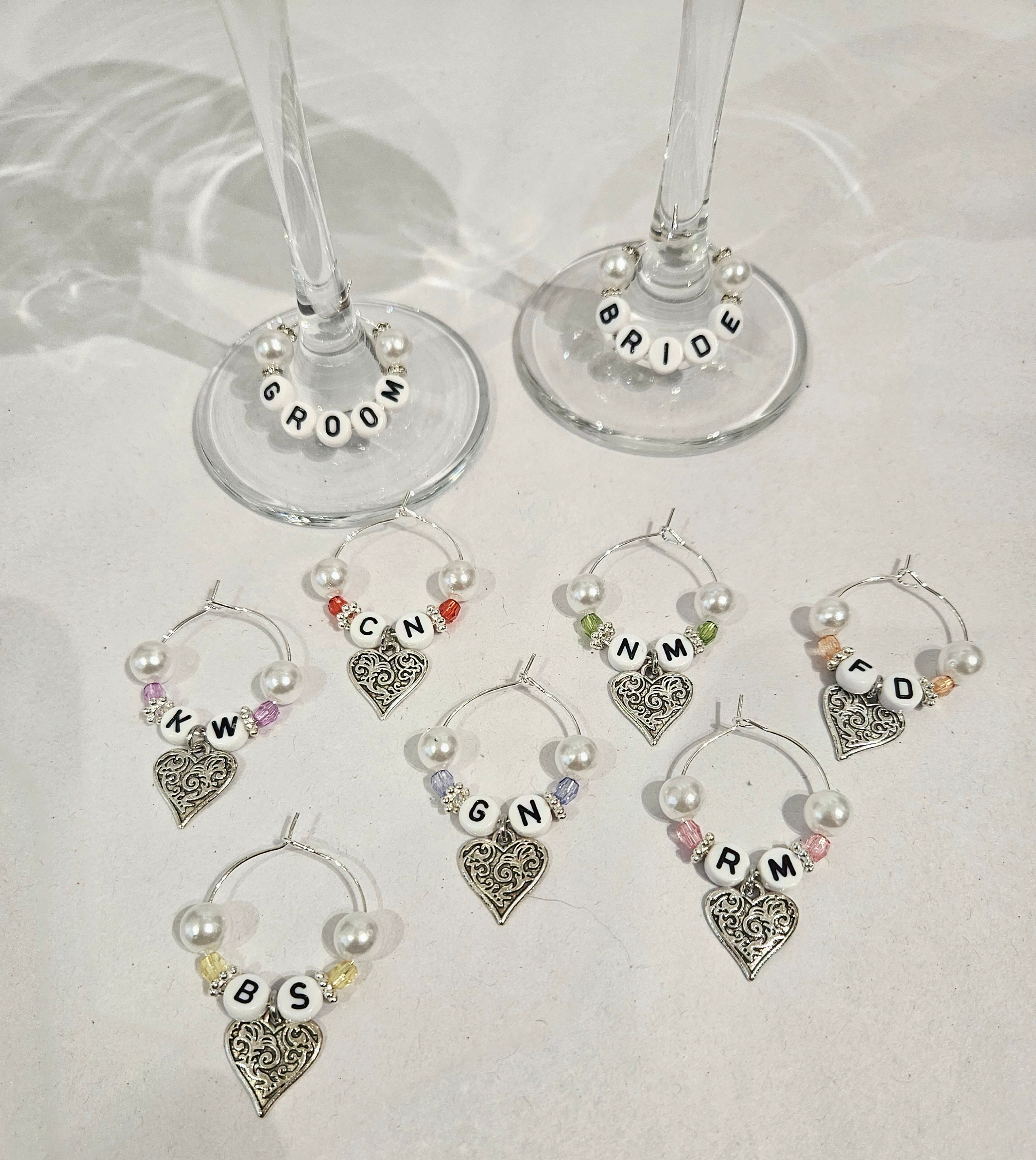 silver colour wine glass charms with pearl and coloured beads, silver coloured heart and letter beads