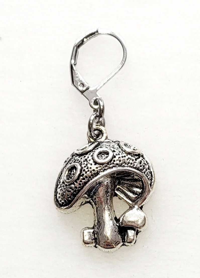Thumbnail: toadstool shaped silver coloured metal charm with lever back clasp