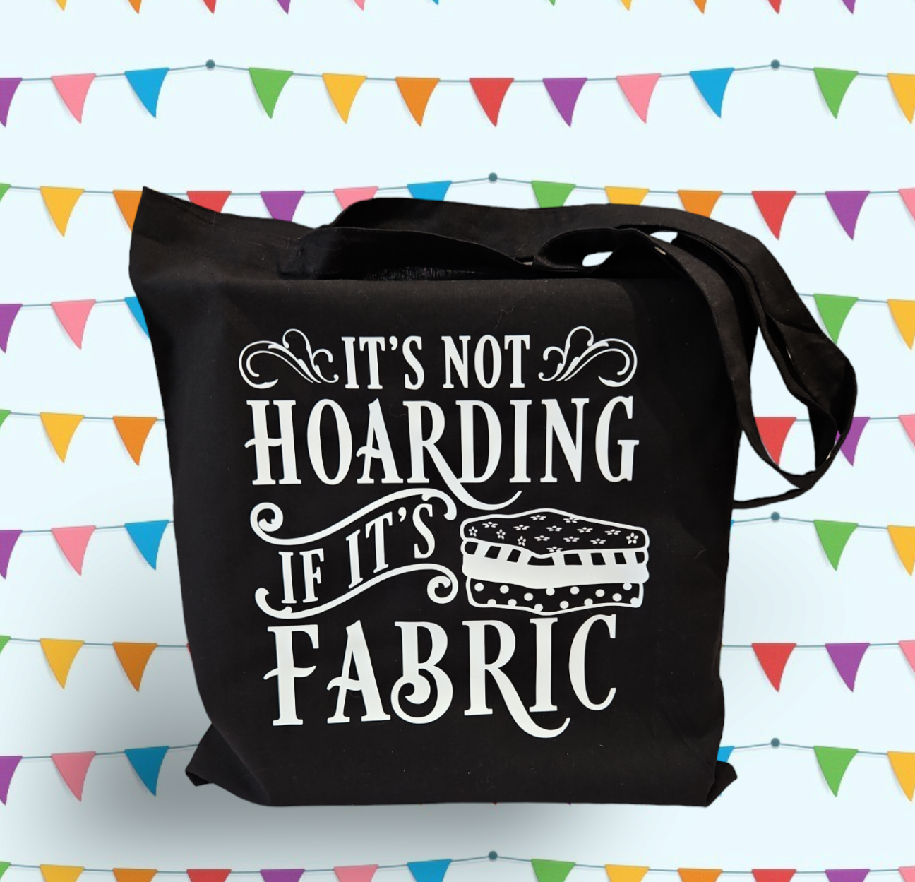 Black cotton tote bag with words "It's not hoarding if it's fabric" and fabric bale decal