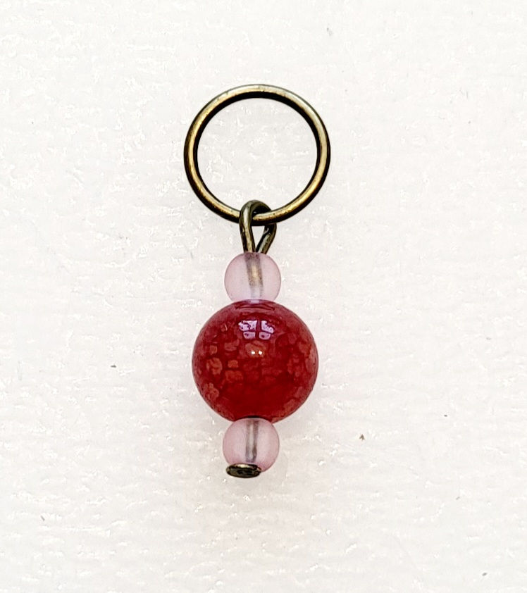 Thumbnail: Red crackle bead on bronze coloured metal ring