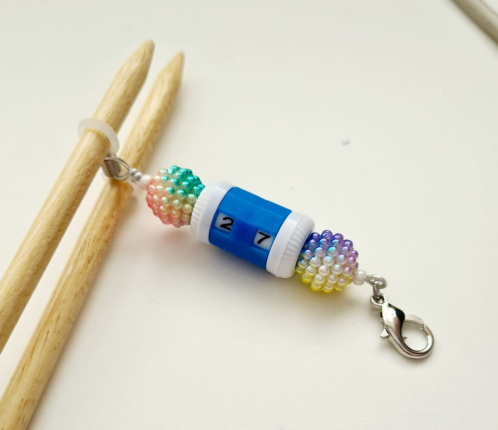 Thumbnail: row counter with beads at each end.  Lobster clasp at one end and 2 rubber rings at the other end on knitting needles.