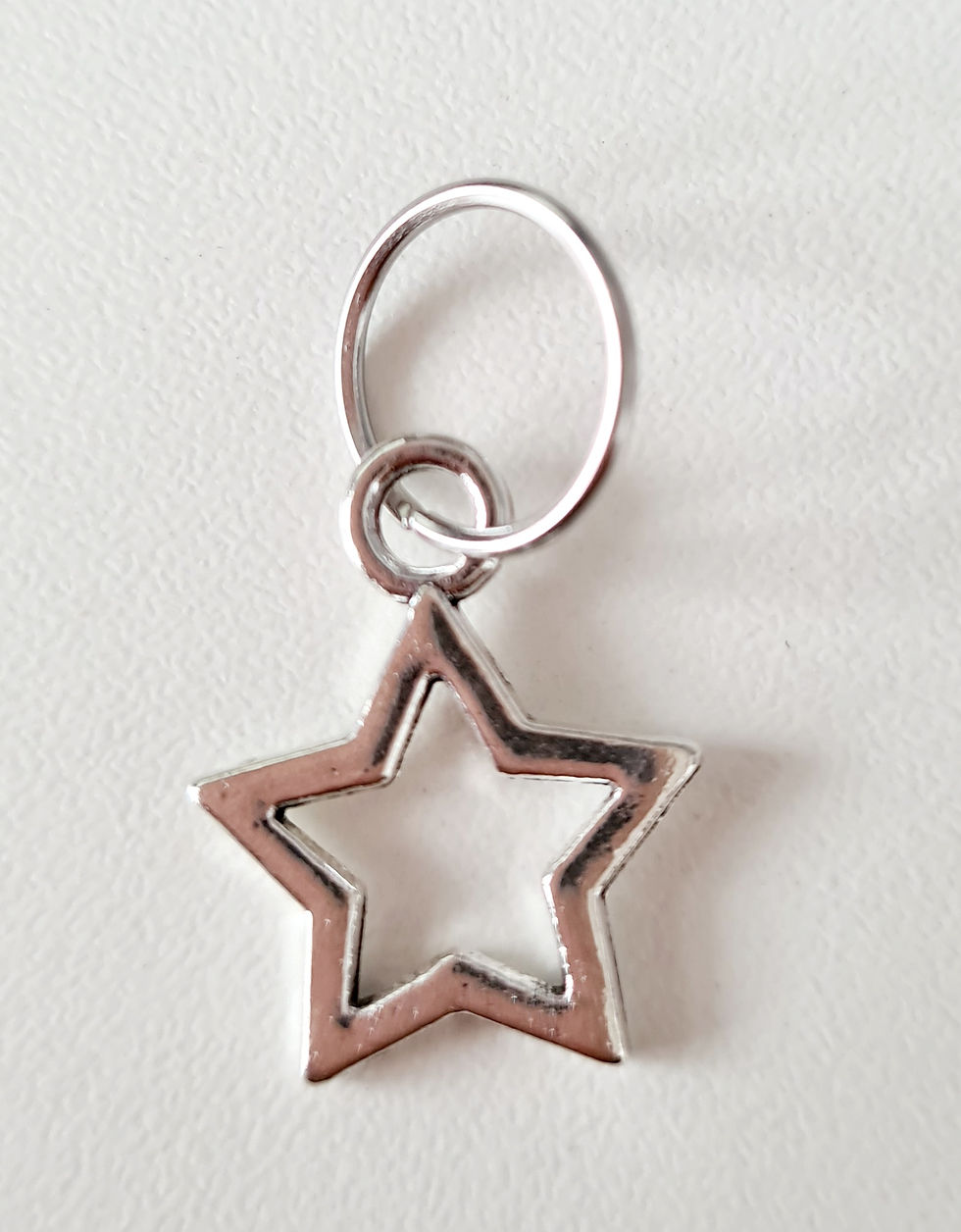 Thumbnail: star shaped silver coloured metal charm with ring