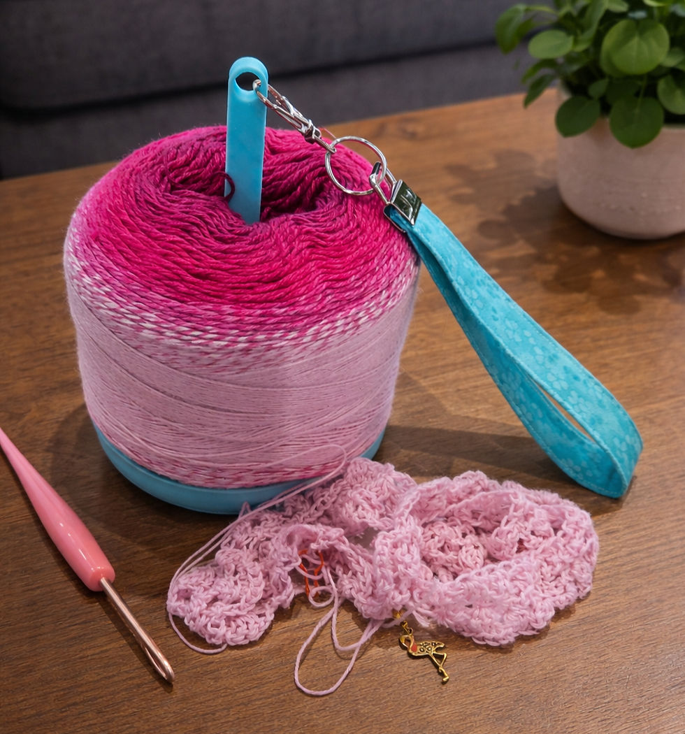 Thumbnail: blue yarn spinner and wristlet with pink yarn on