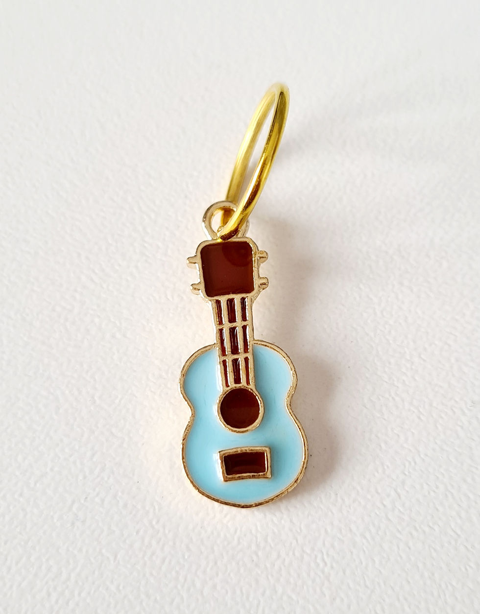 Thumbnail: blue guitar shaped enamel charm on gold coloured base with clasp