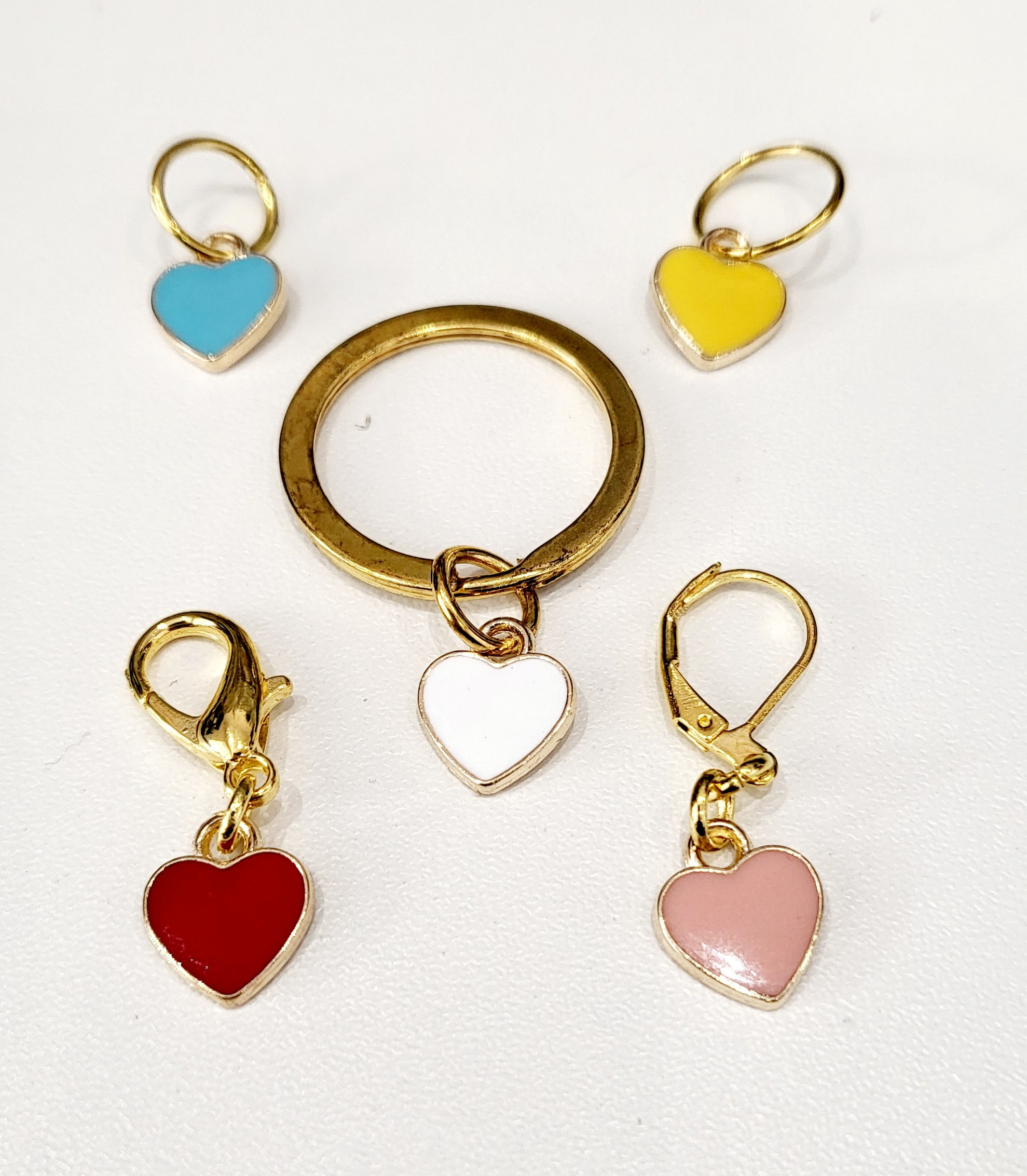 blue, yellow, white, red and pink enamel heart shaped charms on gold coloured metal back with clasps