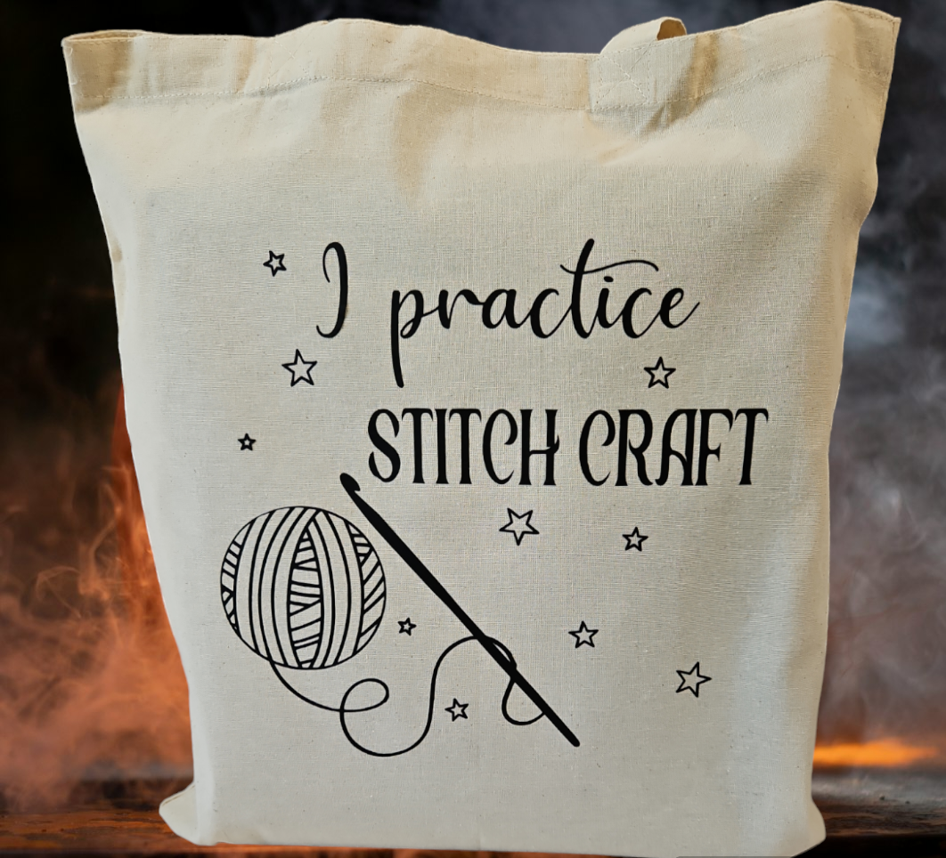 Natural cotton tote bag with words "I practice stitch craft" and yarn and crochet hook with stars decal