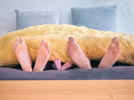 family sleeping showing their feet