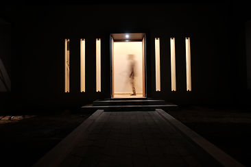 View of home from courtyard at night