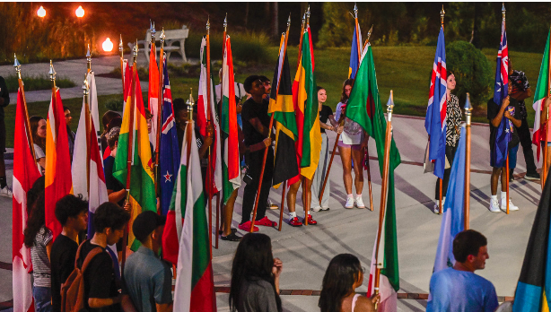 Students hold different nation's flags at the end of the Peace Walk. University Relations photo