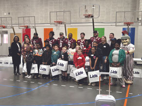 Troy football team teams up and gives back