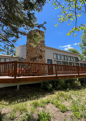 Side angle of the restored deck and chimney setup, showing stain and wood finish.