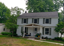 Roof Replacement Peak Roofing LLC white house with strom grey shingles in Jenison, MI