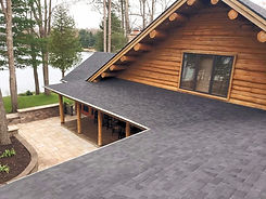 Peak Roofing LLC Roof replacement brilliant black shingles on a log home