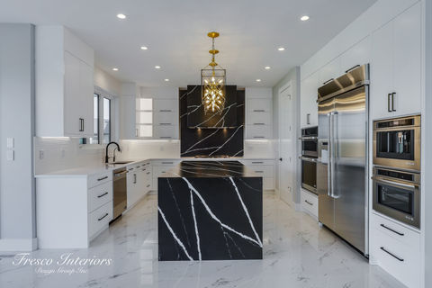 black and white quartz, white countertop, black countertop, white cabinets, black hardware, gold lighting, modern style, marble flooring, double wall oven, horizontal pulls, bold kitchen
