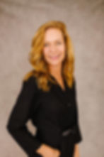 President of Association Management at Gassen HOA Management, Kristi Hoffman pictured here in front of a plain backdrop.
