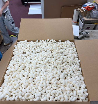 Cardboard box filled with packing peanuts for shipping