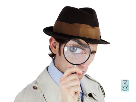 male detective holding magnifying glass to eye