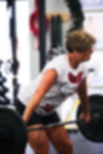 Female participant lifting a barbell.